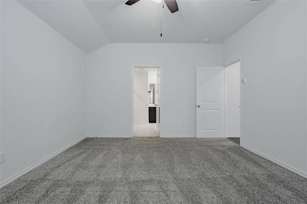 2904 Goodrich Street, Royse City, TX 75189 Spacious room featuring gray textured carpet, white baseboards, and a ceiling fan
