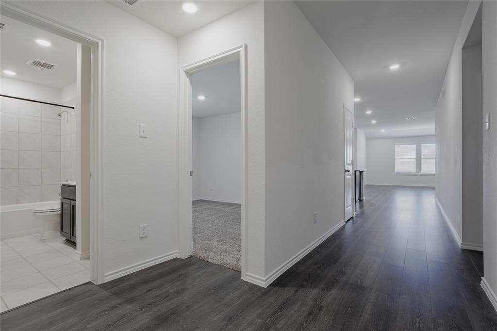 2904 Goodrich Street, Royse City, TX 75189 Hallway with dark wood-finish flooring, recessed lighting, and white baseboards