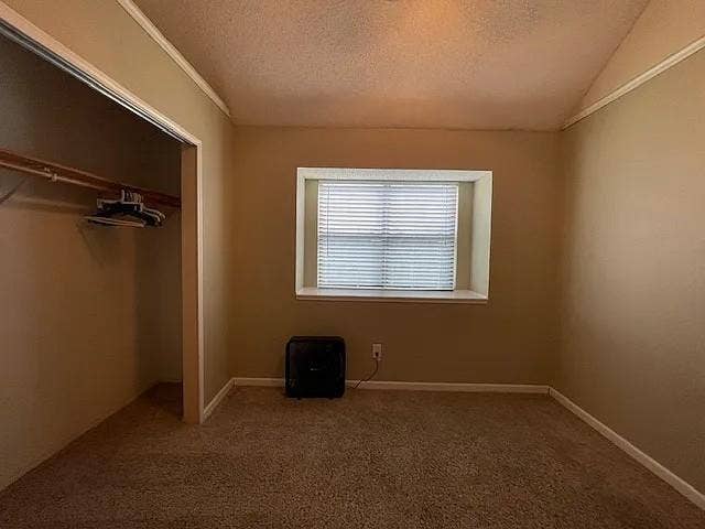 2062 Bronco Lane, Keller, TX 76248 Carpeted interior space featuring a window with horizontal blinds, neutral wall tones, white trim, and an open closet