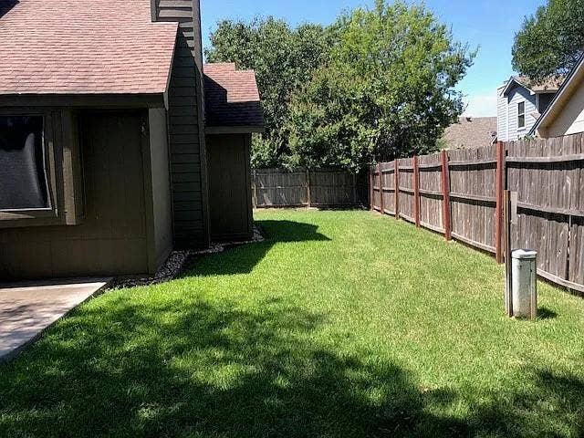 2062 Bronco Lane, Keller, TX 76248 Expansive backyard featuring a manicured lawn, a full wood privacy fence, and a concrete patio slab