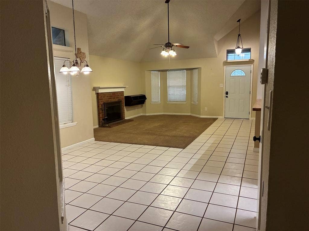2062 Bronco Lane, Keller, TX 76248 Vaulted ceilings, brick fireplace, bay window, ceiling fan, and white tile flooring