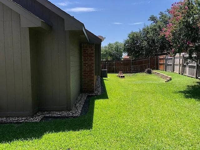 2062 Bronco Lane, Keller, TX 76248 Spacious backyard featuring a lush green lawn, wood privacy fencing, and mature trees
