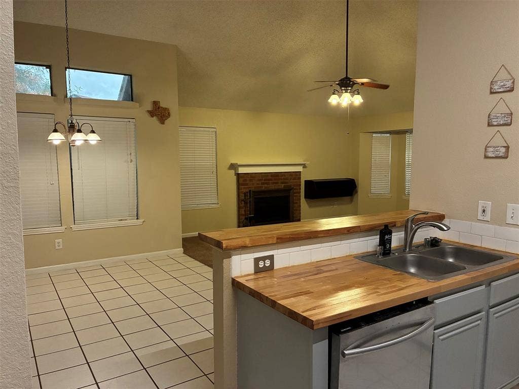 2062 Bronco Lane, Keller, TX 76248 Kitchen with wood-finish countertops, stainless steel sink, and dishwasher