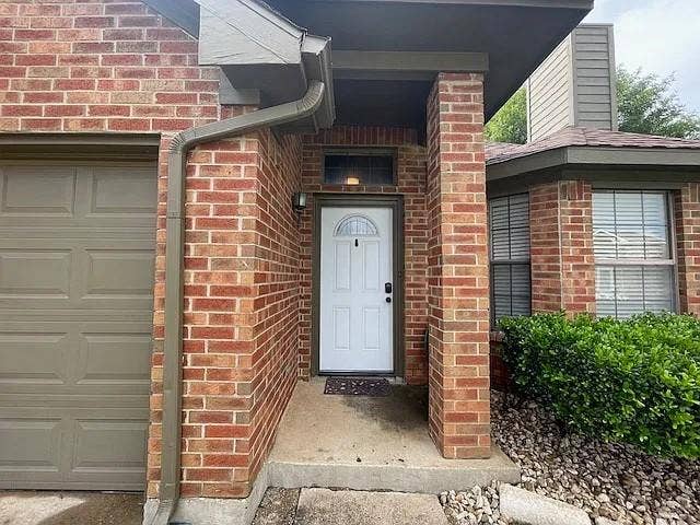 2062 Bronco Lane, Keller, TX 76248 Brick exterior with a covered entry, featuring a white paneled front door with an arched lite