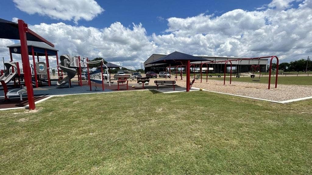 LOT 919 Tahoka Road, Mabank, TX 75156 Outdoor recreation area featuring multiple play structures with slides, swings, and shade coverings