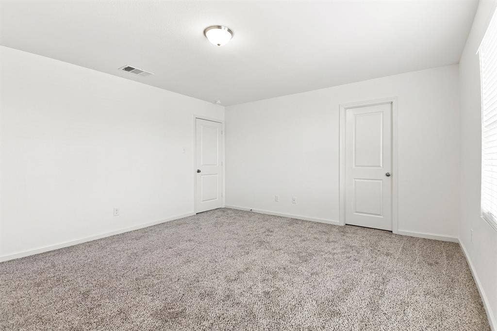 6520 Calico Lane, Forney, TX 75126 Spacious room featuring neutral carpeting, white painted walls, and white trim