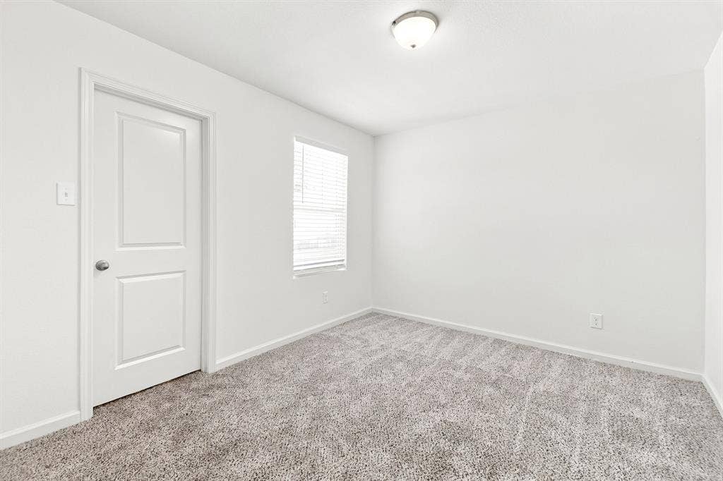 6520 Calico Lane, Forney, TX 75126 Room featuring light gray textured carpeting, white walls, and a single window with horizontal blinds