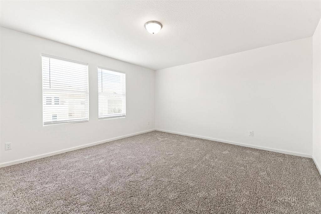 6520 Calico Lane, Forney, TX 75126 Spacious room featuring neutral carpeting and white painted walls