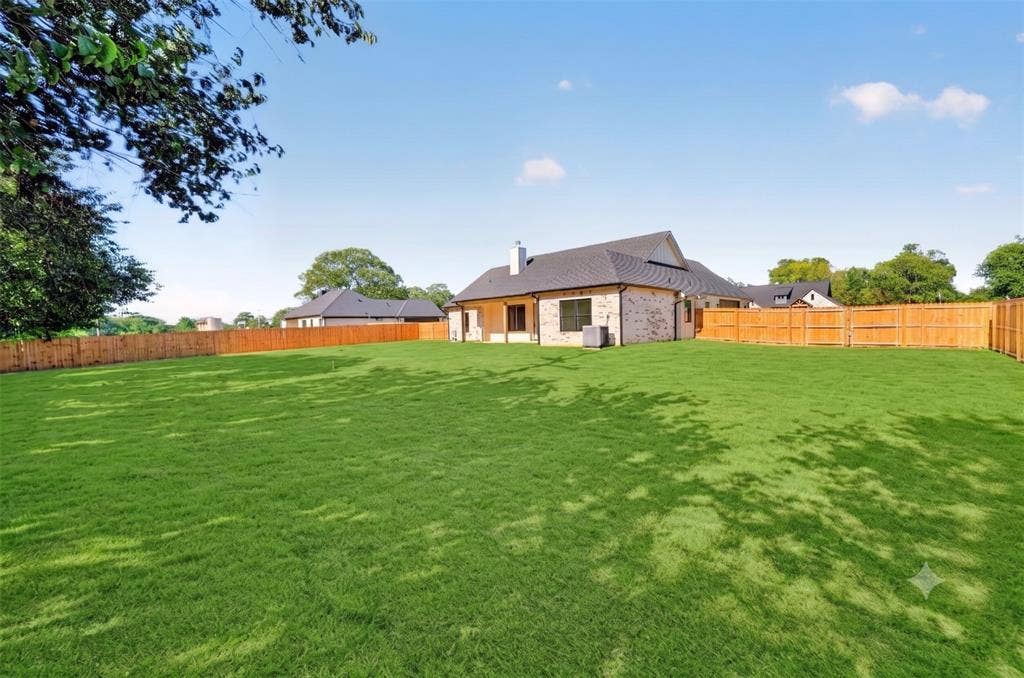 Back view of the half acre (.50) lot at. The backyard designed intentionally to allow room for a site built shop or in-ground pool through the double gates.