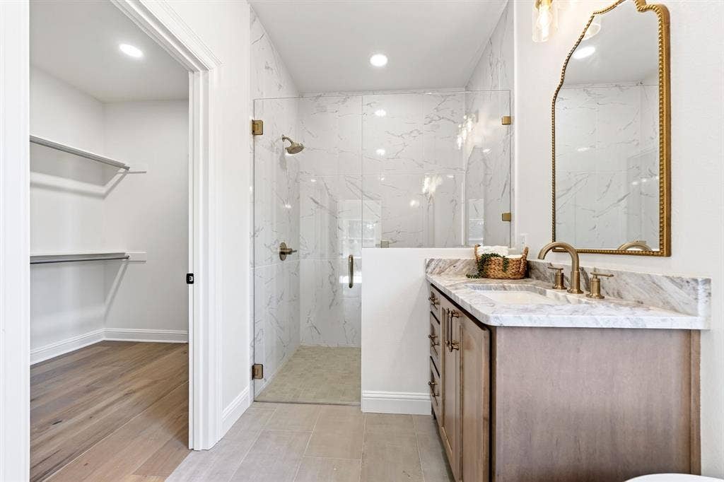 Thoughtfully designed, the primary walk-in closet flows from the primary en-suite.