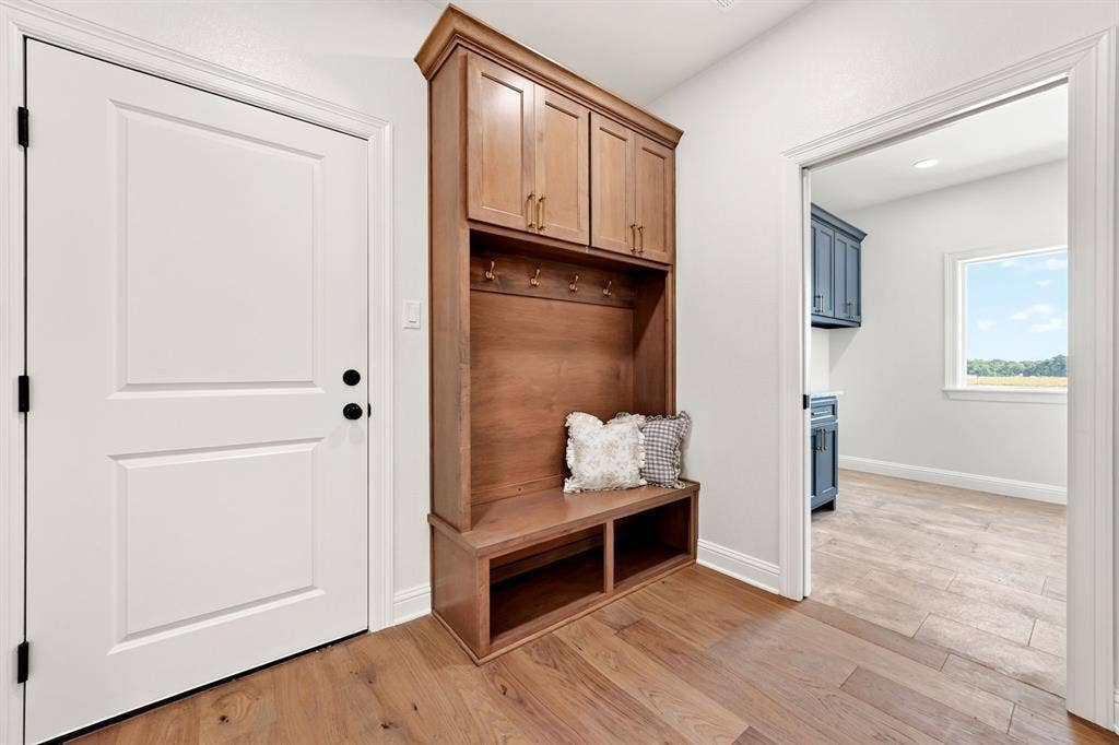 Just off the garage, the mudroom built in offers a unique space to drop coats, purses, shoes, backpacks or whatever your heart desires.