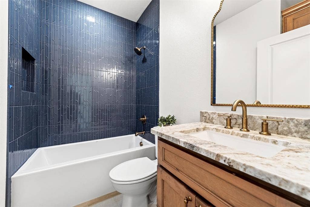 Shared bathroom featuring gorgeous tile selections & modern fixtures.