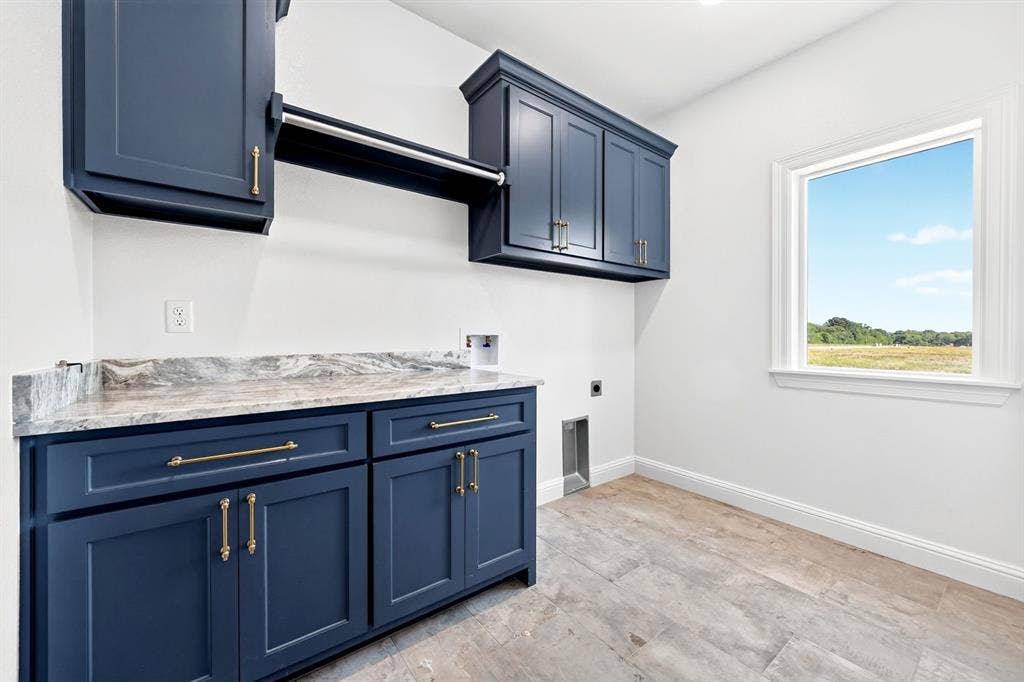 Laundry Room with ample cabinetry for storage, natural lighting & a seamless design with entrances from the mudroom & primary en-suite.