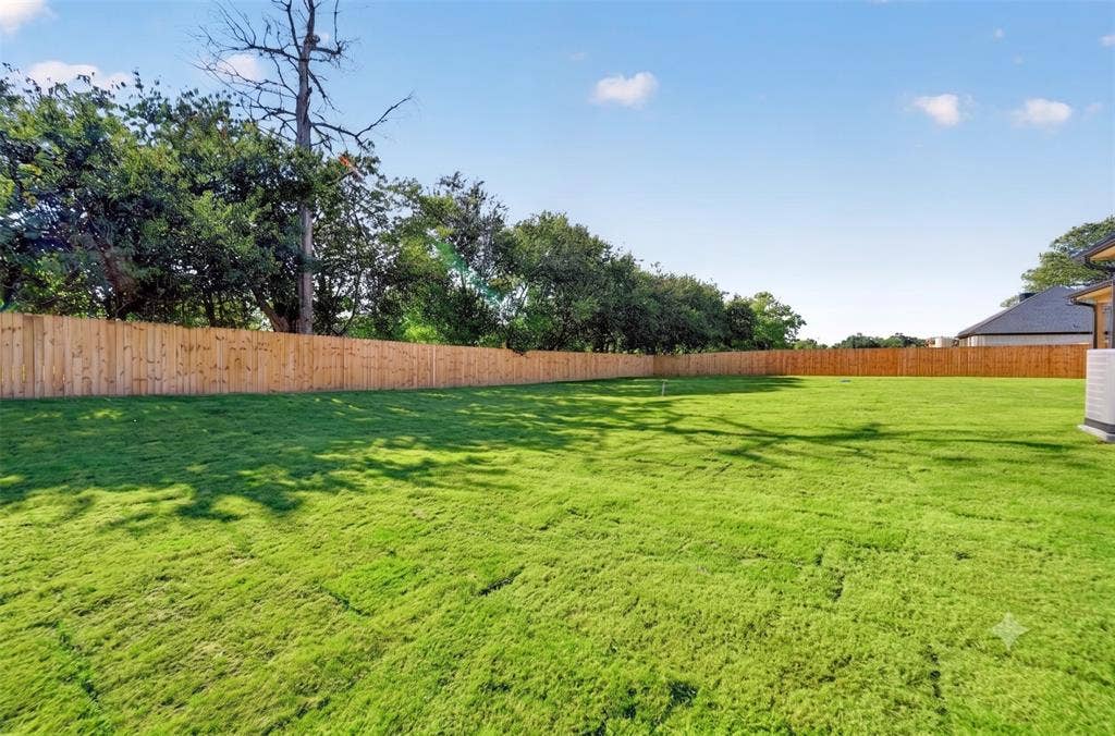 View of 6' privacy fenced backyard with sod & irrigation installed.
