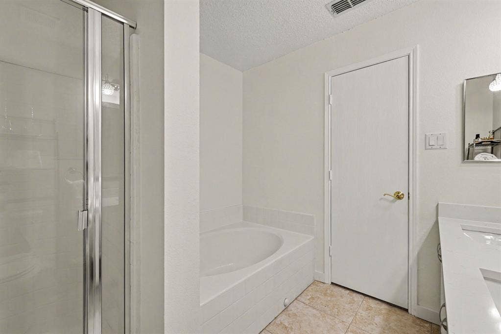 3123 Melrose Drive, McKinney, TX 75070 Primary bathroom with walk-in shower and garden tub