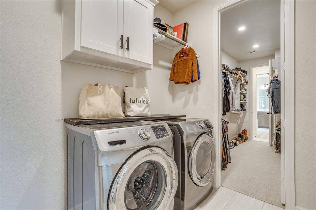 Laundry room that connects to one of the primary walk-in closets