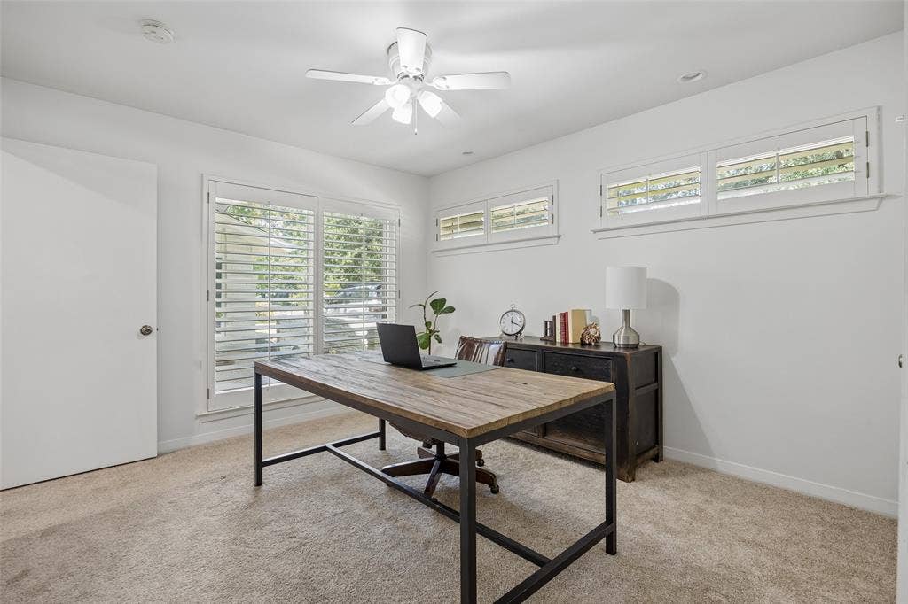 4110 Shady Hill Drive, Dallas, TX 75229 A downstairs bedroom currently used as an office offers abundant natural light and flexible functionality.