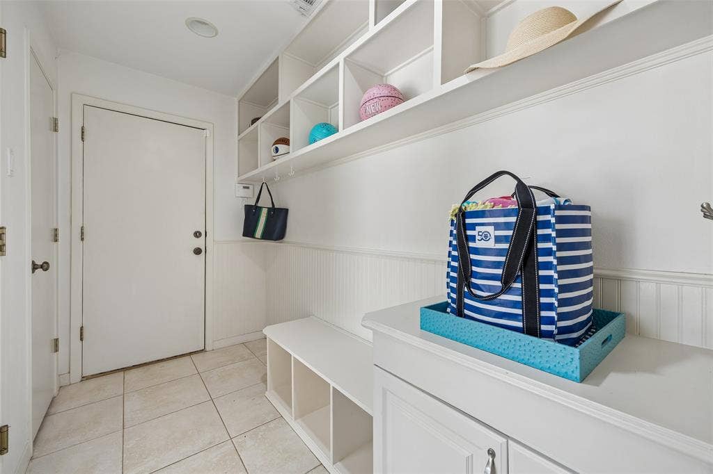 4110 Shady Hill Drive, Dallas, TX 75229 A thoughtfully designed mudroom offers built-in cubbies, hooks, bench seating, and additional storage for everyday organization.