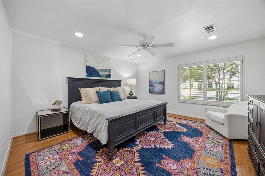 4110 Shady Hill Drive, Dallas, TX 75229 The spacious downstairs primary suite is located on the opposite side of the house from all other bedrooms with great features including wood floors, spacious walk-in closet and room for a sitting area. Ensuite bathroom attached.