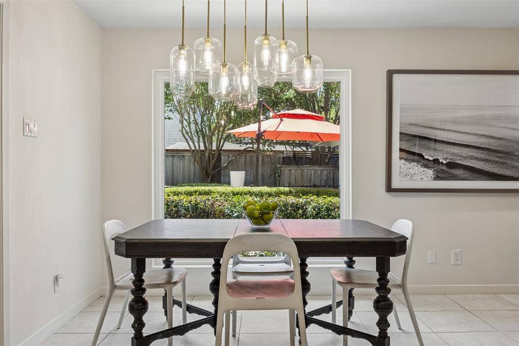 4110 Shady Hill Drive, Dallas, TX 75229 The bright breakfast nook features a statement light fixture and picturesque windows overlooking the backyard.