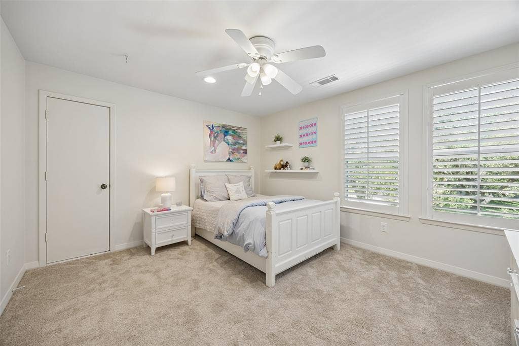4110 Shady Hill Drive, Dallas, TX 75229 A spacious upstairs guest bedroom with abundant natural light, a walk-in closet, and access to a Jack-and-Jill bath.
