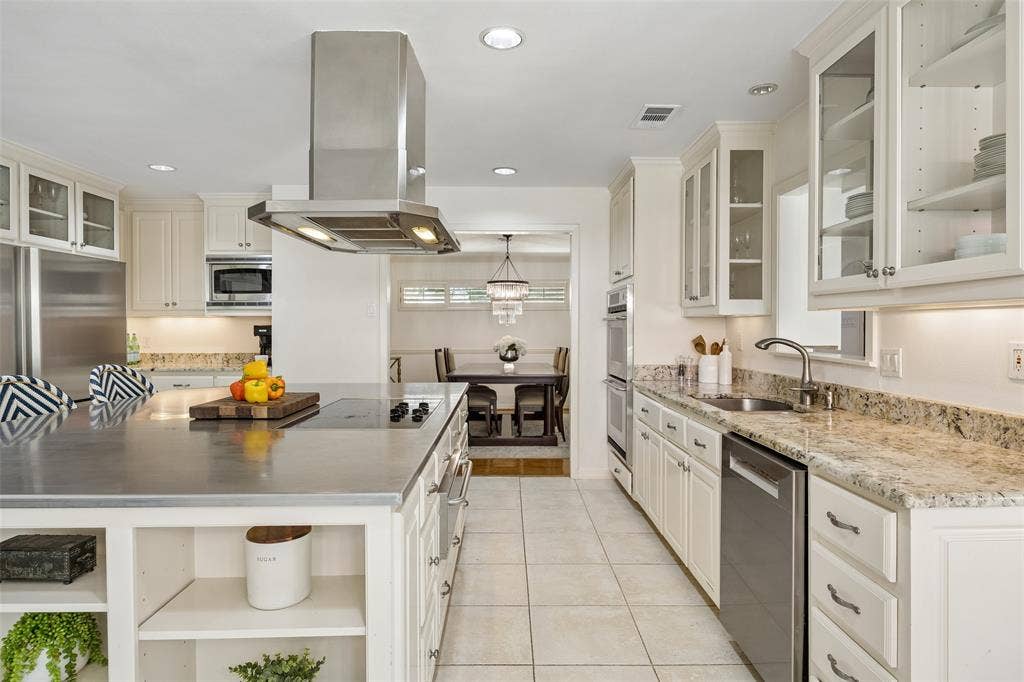 4110 Shady Hill Drive, Dallas, TX 75229 Another view of the kitchen highlights abundant cabinetry, generous counter space, stainless steel appliances, and a functional layout designed for everyday living.