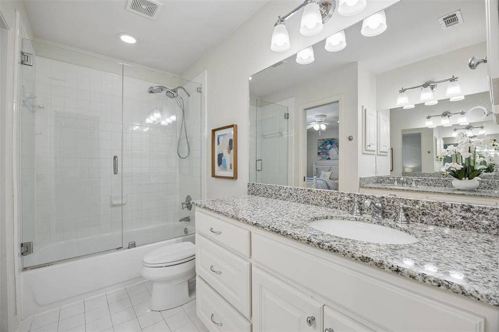 4110 Shady Hill Drive, Dallas, TX 75229 A second view of the upstairs Jack-and-Jill bath highlights the tub-shower combination, granite-topped vanity, and generous storage.