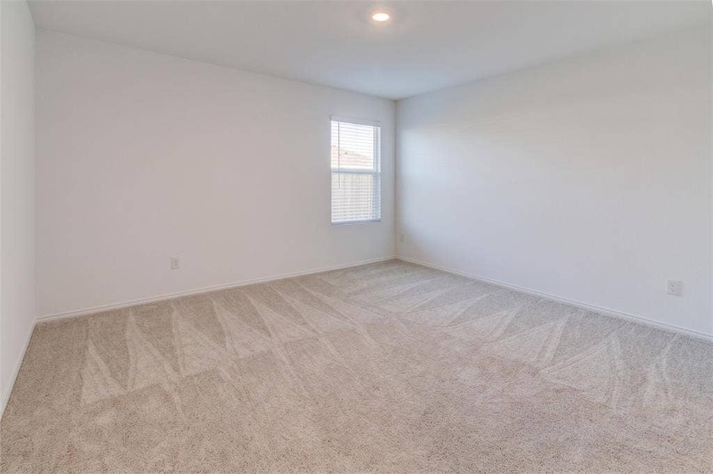 6005 Determine Lane, Forney, TX 75126 Carpeted room featuring a single window with blinds and recessed lighting