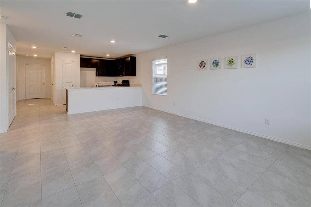 6005 Determine Lane, Forney, TX 75126 Spacious living area featuring light-toned tile flooring throughout