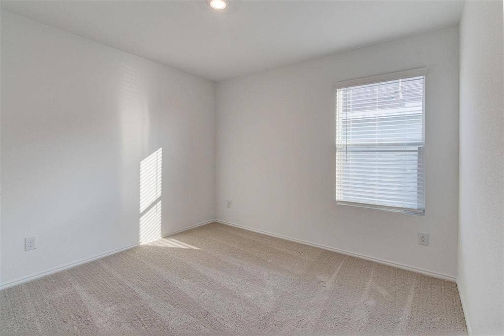 6005 Determine Lane, Forney, TX 75126 Bright interior space featuring light-colored carpeting and white walls