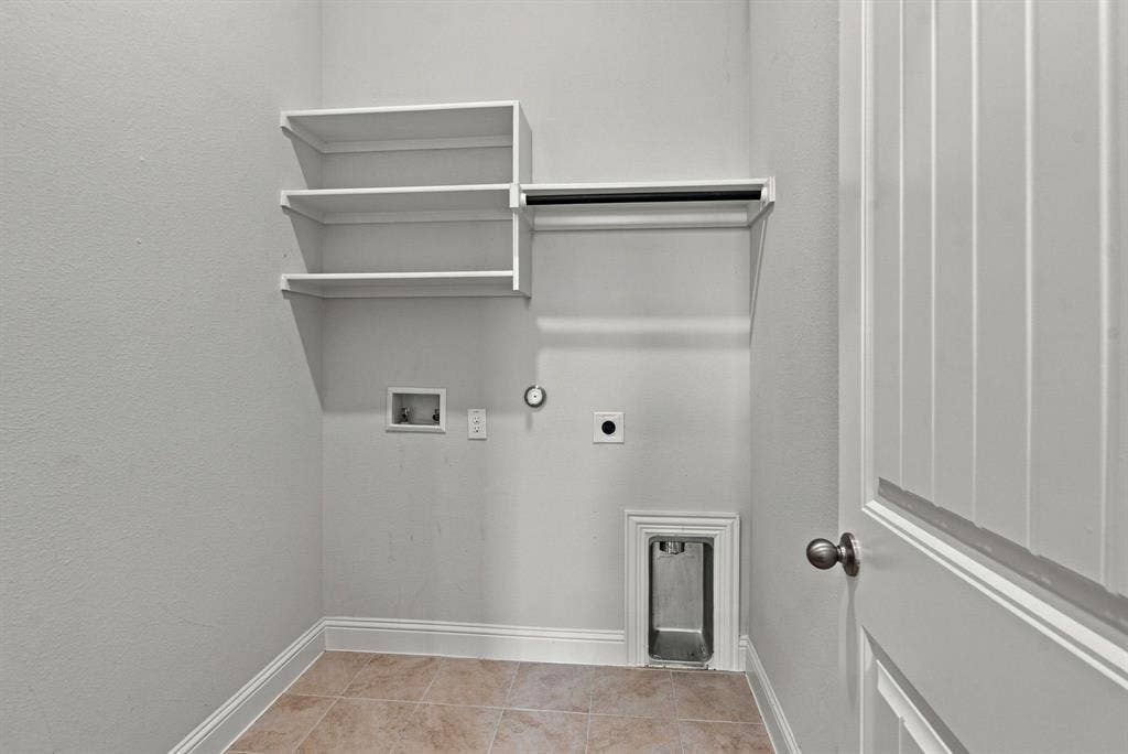 944 Tara Court, Haslet, TX 76052 Dedicated laundry area featuring built-in shelving, a hanging rod, tile flooring, and essential utility hookups