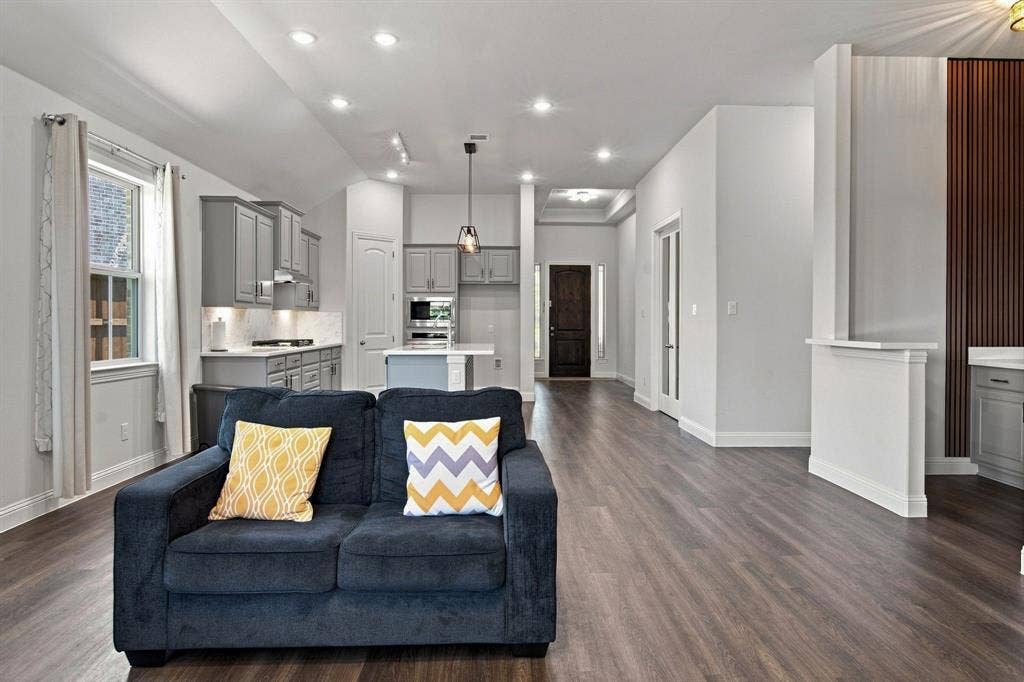 944 Tara Court, Haslet, TX 76052 Open-concept living space featuring wood-finish flooring, recessed lighting, and a kitchen with gray cabinetry