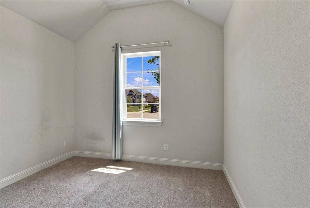 944 Tara Court, Haslet, TX 76052 Bright room featuring a vaulted ceiling and a double-hung window