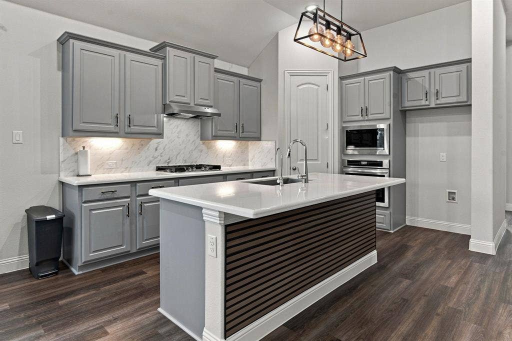 944 Tara Court, Haslet, TX 76052 Chef's kitchen featuring gray cabinetry with shaker-style doors, quartz countertops, and a marble subway tile backsplash