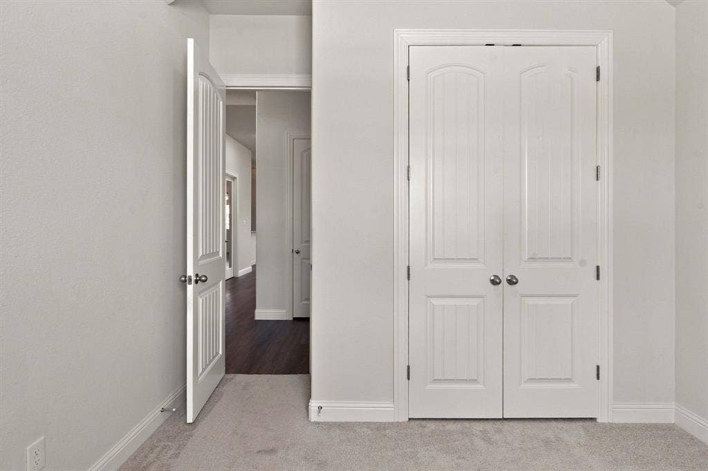 944 Tara Court, Haslet, TX 76052 White bi-fold closet doors with panel detailing