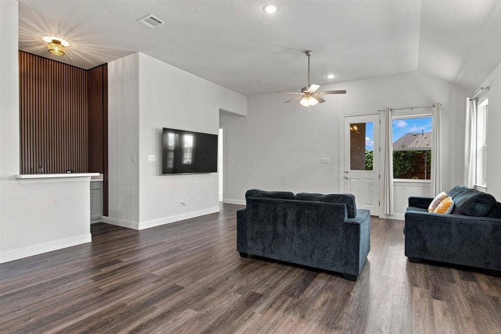 944 Tara Court, Haslet, TX 76052 Spacious living area featuring wood-finish flooring, recessed lighting, and a vaulted ceiling with a ceiling fan