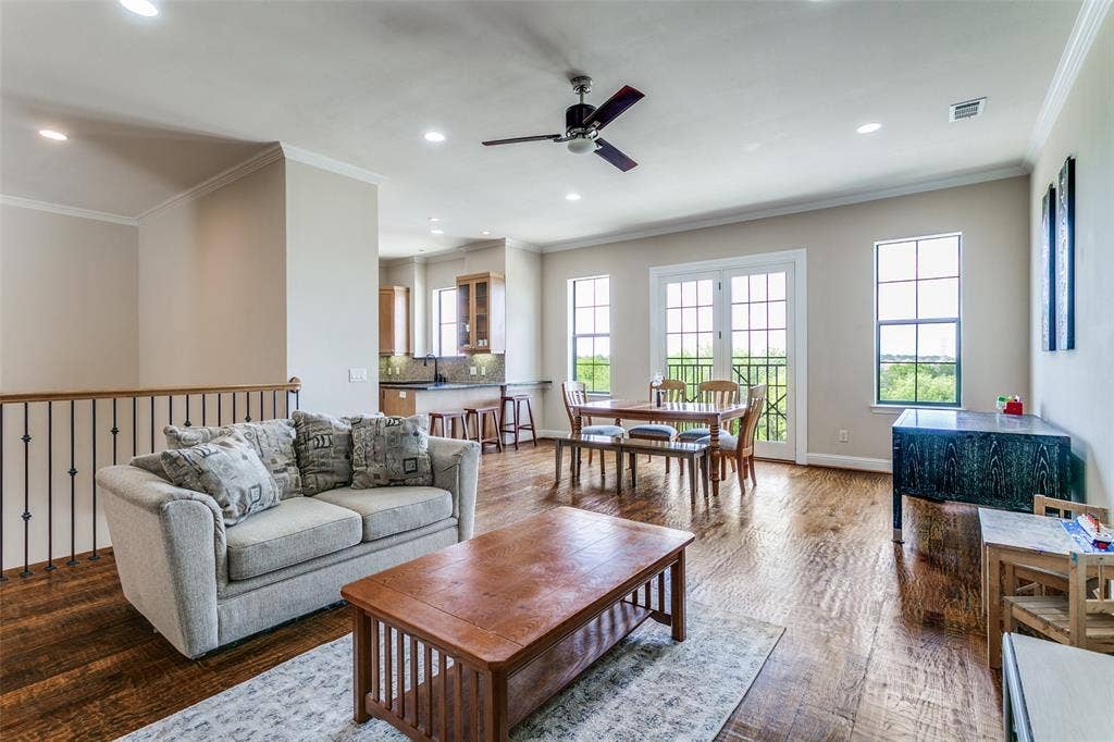 Generous living area with a bright, airy feel and warm wood flooring that adds character to the space.