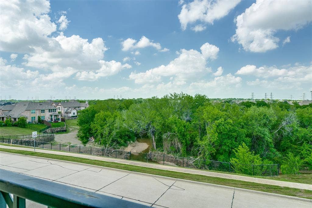 Enjoy scenic views of the surrounding green space from the front the Juliet balcony.