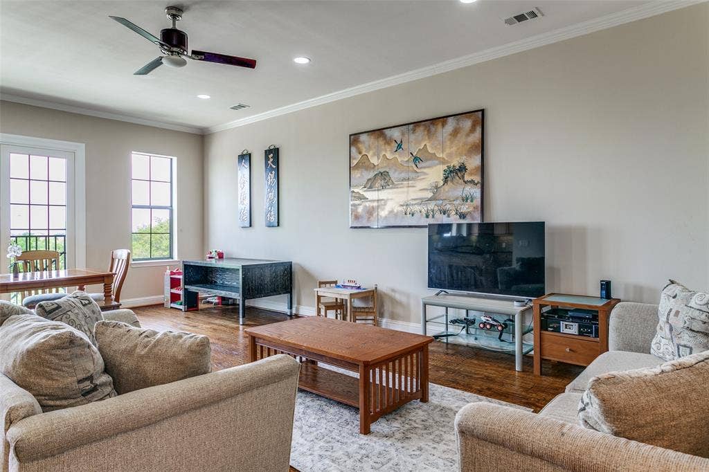 Spacious living room with an open layout and views of the surrounding green space.