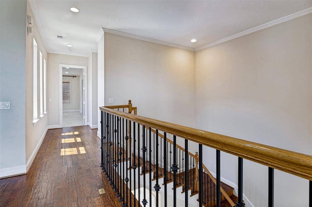 Light filled hallway with an abundance of windows overlooking the interior courtyard.