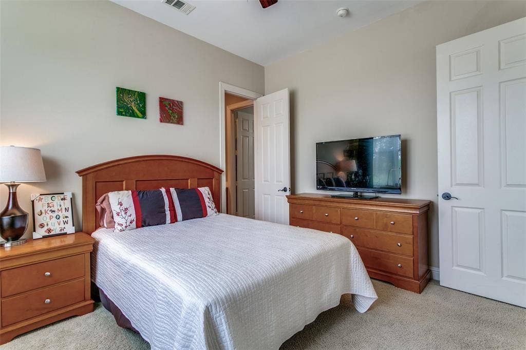 Spacious secondary bedroom with natural light and convenient access to the shared bathroom.