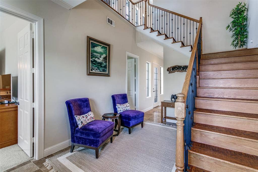 Welcoming entryway with an open feel and a hardwood staircase leading to the upper level.