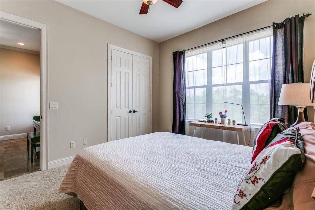 Comfortable secondary bedroom featuring front-facing views of green space.