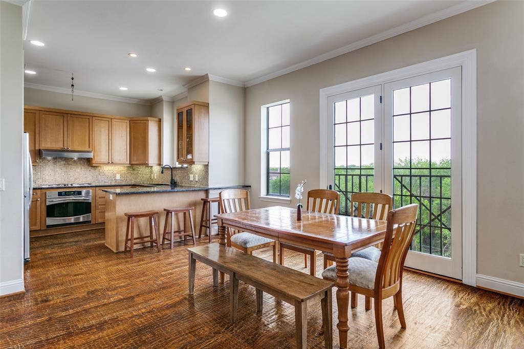 Hand-scraped wood floors add warmth and character to the dining space.
