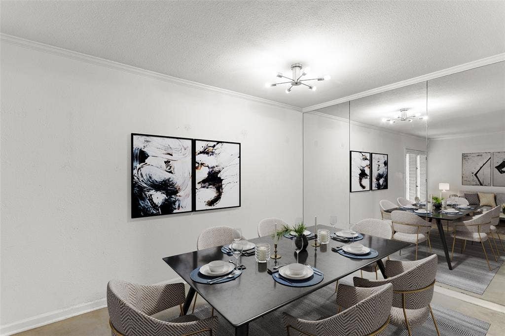 5916 Birchbrook Drive, #129, Dallas, TX 75206 Virtually Staged Dining area featuring a full-wall mirrored accent, crown molding, and recessed lighting