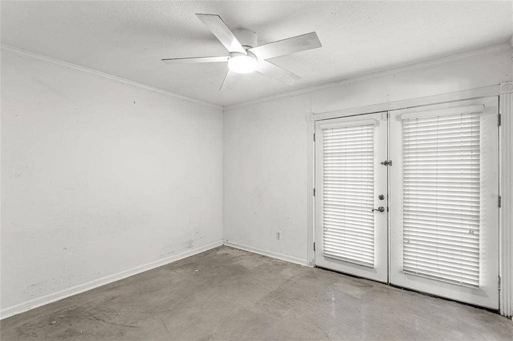 5916 Birchbrook Drive, #129, Dallas, TX 75206 Room featuring white walls, concrete-finish flooring, and a ceiling fan with integrated lighting