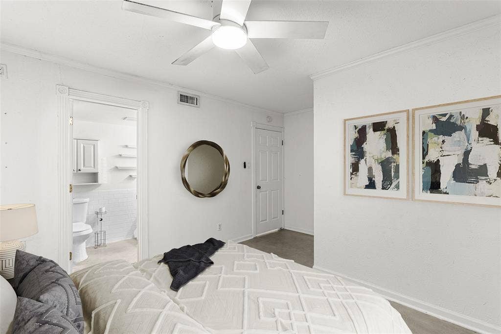 5916 Birchbrook Drive, #129, Dallas, TX 75206 Virtually Staged Bedroom with bright white walls, a ceiling fan, and access to a bathroom featuring white subway tile