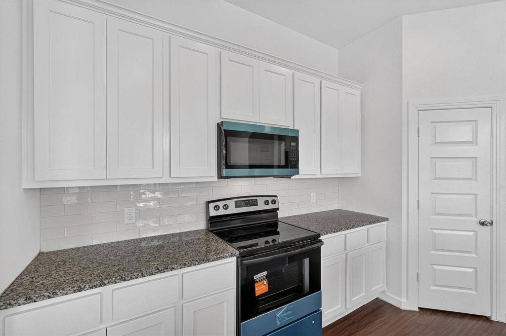 2832 Lolita Way, Forney, TX 75126 Kitchen featuring white shaker-style cabinetry, dark speckled countertops, and a white subway tile backsplash