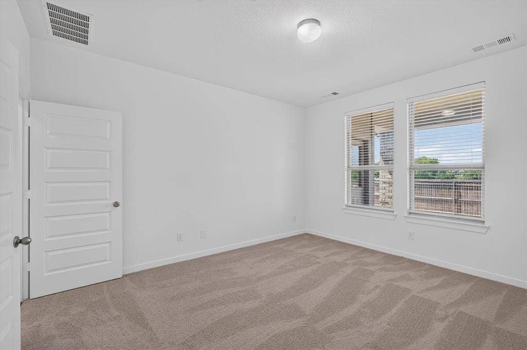 2832 Lolita Way, Forney, TX 75126 Neutral-toned carpeting paired with bright white walls