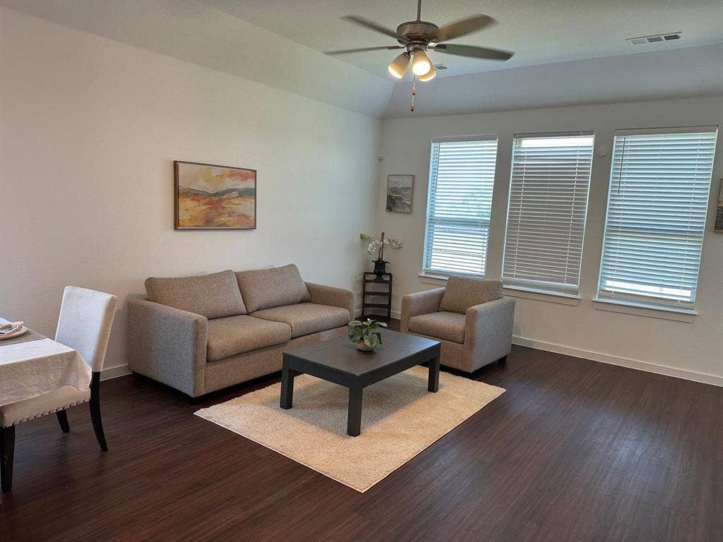 2832 Lolita Way, Forney, TX 75126 Tray ceiling with a ceiling fan, wood-finish flooring, and multiple windows with blinds